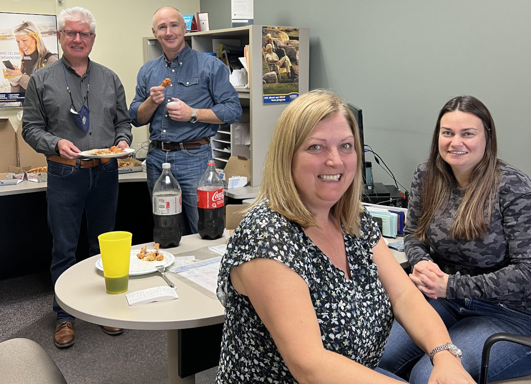 Staff enjoying a pizza lunch sponsored by CUDGC (Credit Union Deposit Guarantee Corporation) to celebrate our 85th anniversary!